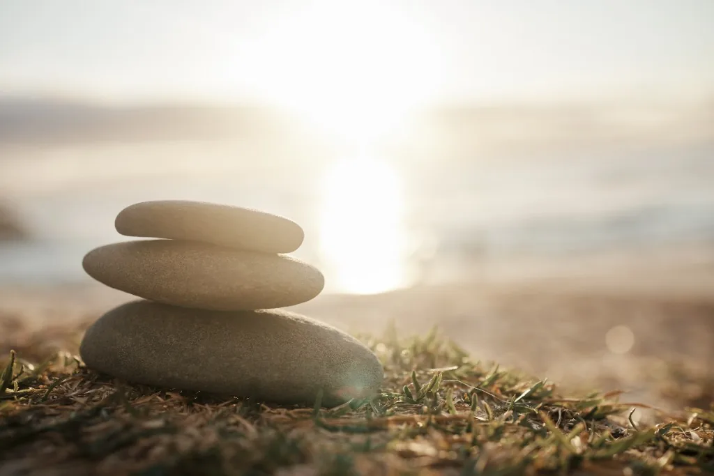 Balanced stones on a quiet shoreline for Mindfulness training